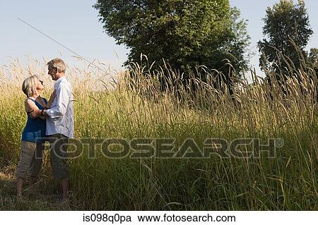 Couple in field View Large Photo Image Stock Image - Couple in field. Fotosearch