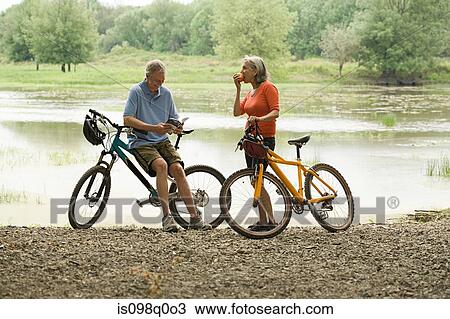 Stock Image - Cyclists taking a break. Fotosearch