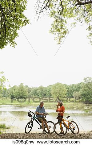 Cyclists taking a break View Large Photo Image Stock Photo - Cyclists taking a break. Fotosearch