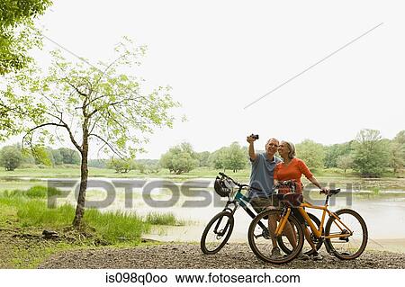 Picture - Cyclists with camera. Fotosearch