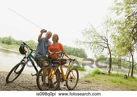 Stock Image - Cyclists with camera. Fotosearch