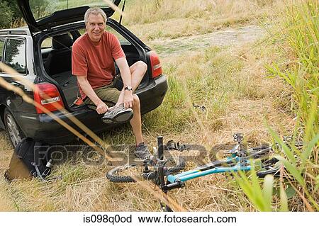 Man with bicycle and car View Large Photo Image Stock Image - Man with bicycle and car. Fotosearch