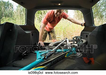 Stock Image - Man with bicycle in car. Fotosearch