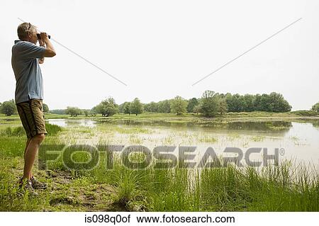 Man with binoculars View Large Photo Image Stock Image - Man with binoculars. Fotosearch