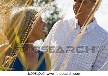 Mature couple in field View Large Photo Image Stock Image - Mature couple in field. Fotosearch