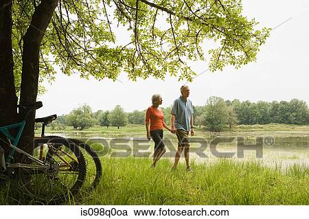 Mature couple walking View Large Photo Image Stock Image - Mature couple walking. Fotosearch