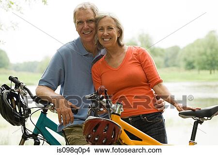 Mature couple with bicycles View Large Photo Image Picture - Mature couple with bicycles. Fotosearch