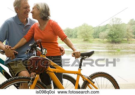 Mature couple with bicycles View Large Photo Image Stock Image - Mature couple with bicycles. Fotosearch
