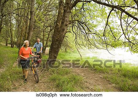 Stock Image - Mature couple with bicycles. Fotosearch