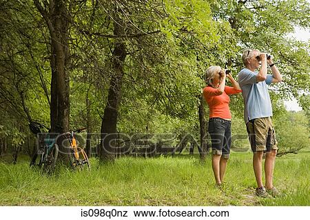 Mature couple with binoculars View Large Photo Image Stock Photo - Mature couple with binoculars. Fotosearch