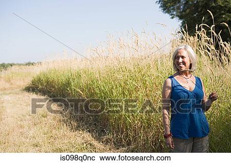 Woman in a field View Large Photo Image Stock Image - Woman in a field. Fotosearch