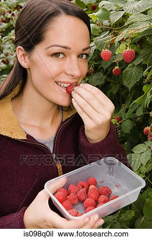 Woman eating fresh raspberries View Large Photo Image Stock Image - Woman eating fresh raspberries. Fotosearch