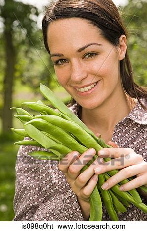 Woman holding fresh runner beans View Large Photo Image Stock Photograph - Woman holding fresh runner beans. Fotosearch