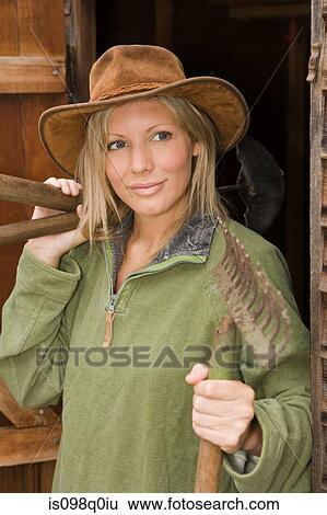 Woman holding gardening tools View Large Photo Image Stock Photograph - Woman holding gardening tools. Fotosearch