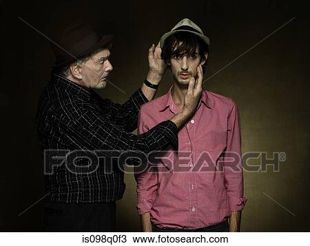 Stock Image - A senior man looking at a young man. Fotosearch