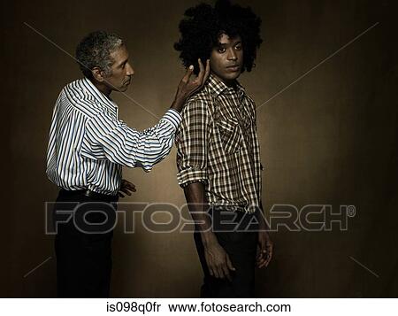Stock Photography - Portrait of a mature and young man. Fotosearch