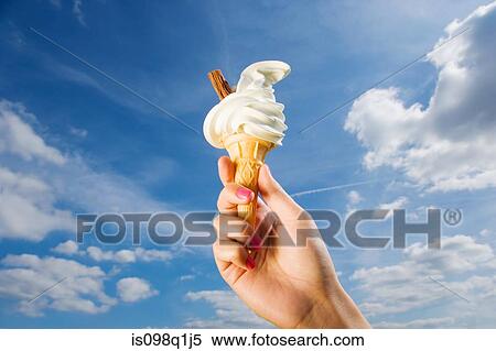 Stock Photography - Person holding ice cream. Fotosearch