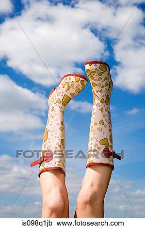 Stock Image - Person wearing rubber boots. Fotosearch