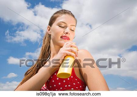 Woman applying suncream View Large Photo Image Stock Image - Woman applying suncream. Fotosearch