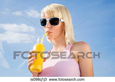 Woman drinking orange juice View Large Photo Image Stock Image - Woman drinking orange juice. Fotosearch