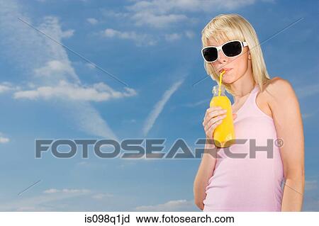 Woman drinking orange juice View Large Photo Image Stock Image - Woman drinking orange juice. Fotosearch