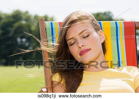Young woman in deckchair View Large Photo Image Stock Image - Young woman in deckchair. Fotosearch