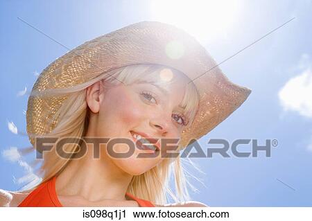 Stock Image - Young woman in hat. Fotosearch