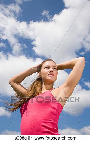 Young woman with arms raised View Large Photo Image Stock Photography - Young woman with arms raised. Fotosearch