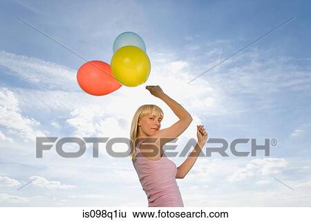 Young woman with balloons View Large Photo Image Stock Photograph - Young woman with balloons. Fotosearch