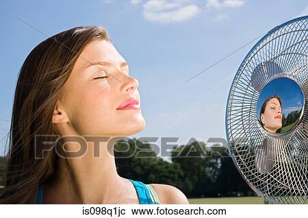 Young woman with fan View Large Photo Image Stock Image - Young woman with fan. Fotosearch