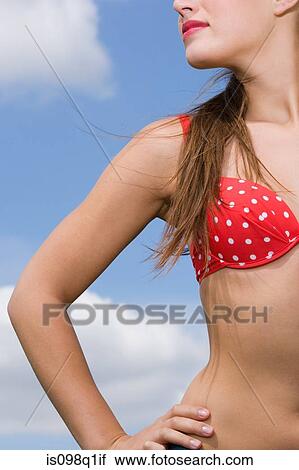 Young woman with hand on hip View Large Photo Image Stock Image - Young woman with hand on hip. Fotosearch