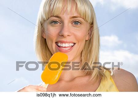 Young woman with ice lolly View Large Photo Image Stock Image - Young woman with ice lolly. Fotosearch