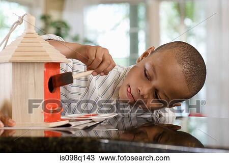 A boy painting a birdhouse View Large Photo Image Stock Image - A boy painting a birdhouse. Fotosearch