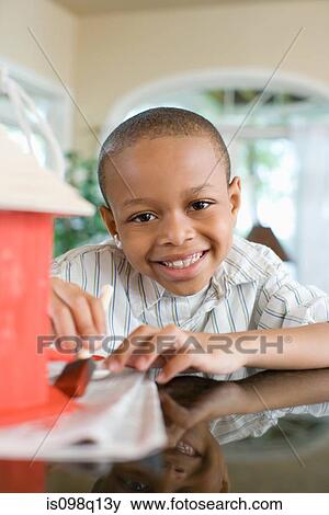 A boy painting a birdhouse View Large Photo Image Stock Photo - A boy painting a birdhouse. Fotosearch