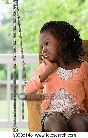 A girl sat on a swing seat View Large Photo Image Picture - A girl sat on a swing seat. Fotosearch