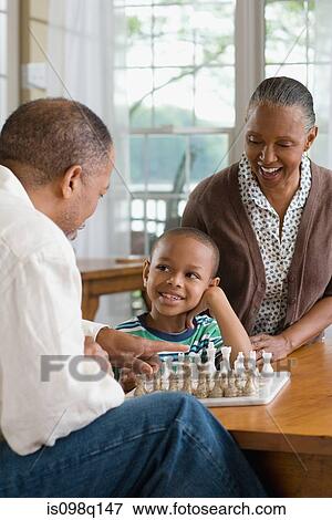 A grandfather and grandson playing chess View Large Photo Image Stock Photo - A grandfather and grandson playing chess. Fotosearch