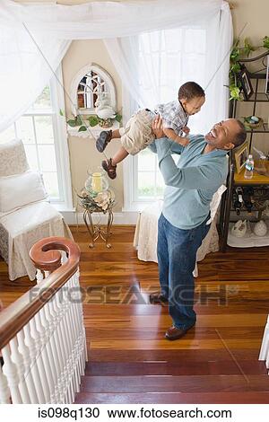 A grandfather lifting his grandson in the air View Large Photo Image Stock Image - A grandfather lifting his grandson in the air. Fotosearch