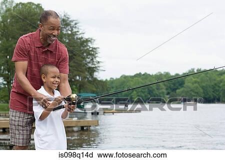 A grandfather teaching his grandson to fish View Large Photo Image Stock Image - A grandfather teaching his grandson to fish. Fotosearch