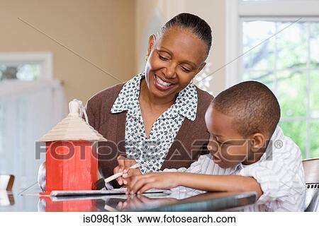 A grandmother and grandson painting a birdhouse View Large Photo Image Stock Image - A grandmother and grandson painting a birdhouse. Fotosearch