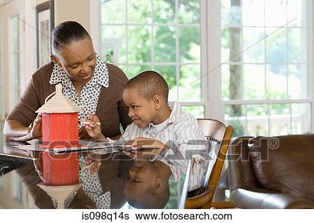 A grandmother and grandson painting a birdhouse View Large Photo Image Stock Photograph - A grandmother and grandson painting a birdhouse. Fotosearch