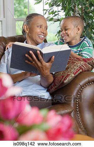 A grandmother and grandson reading a book View Large Photo Image Stock Image - A grandmother and grandson reading a book. Fotosearch
