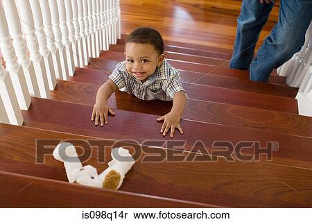 Stock Photography - Boy climbing stairs. Fotosearch