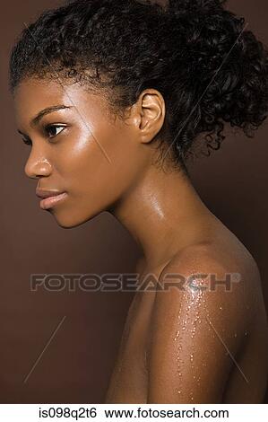 Stock Photograph - Portrait of a young woman covered in water. Fotosearch