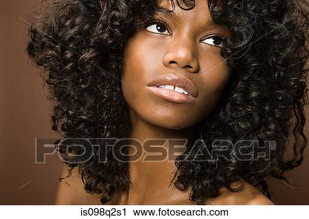 Stock Image - Portrait of a young woman with curly hair. Fotosearch