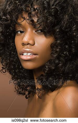 Stock Image - Portrait of a young woman with curly hair. Fotosearch