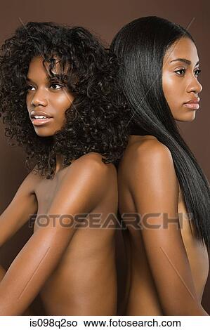 Picture - Portrait of two women back to back. Fotosearch