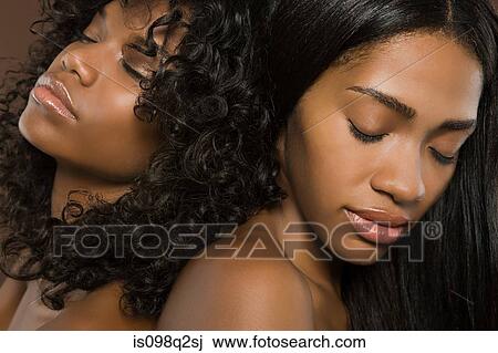 Two young women with their eyes closed View Large Photo Image Stock Image - Two young women with their eyes closed. Fotosearch