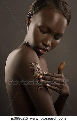 Stock Photography - Young woman exfoliating her arm. Fotosearch