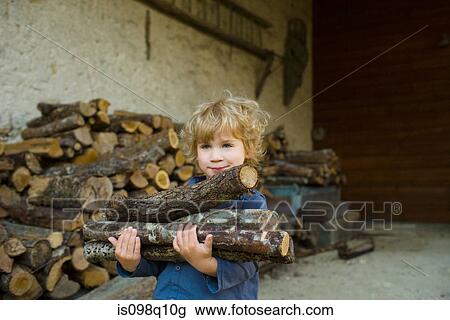 A boy carrying logs View Large Photo Image Stock Image - A boy carrying logs. Fotosearch