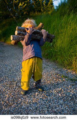 A boy carrying logs View Large Photo Image Stock Photo - A boy carrying logs. Fotosearch